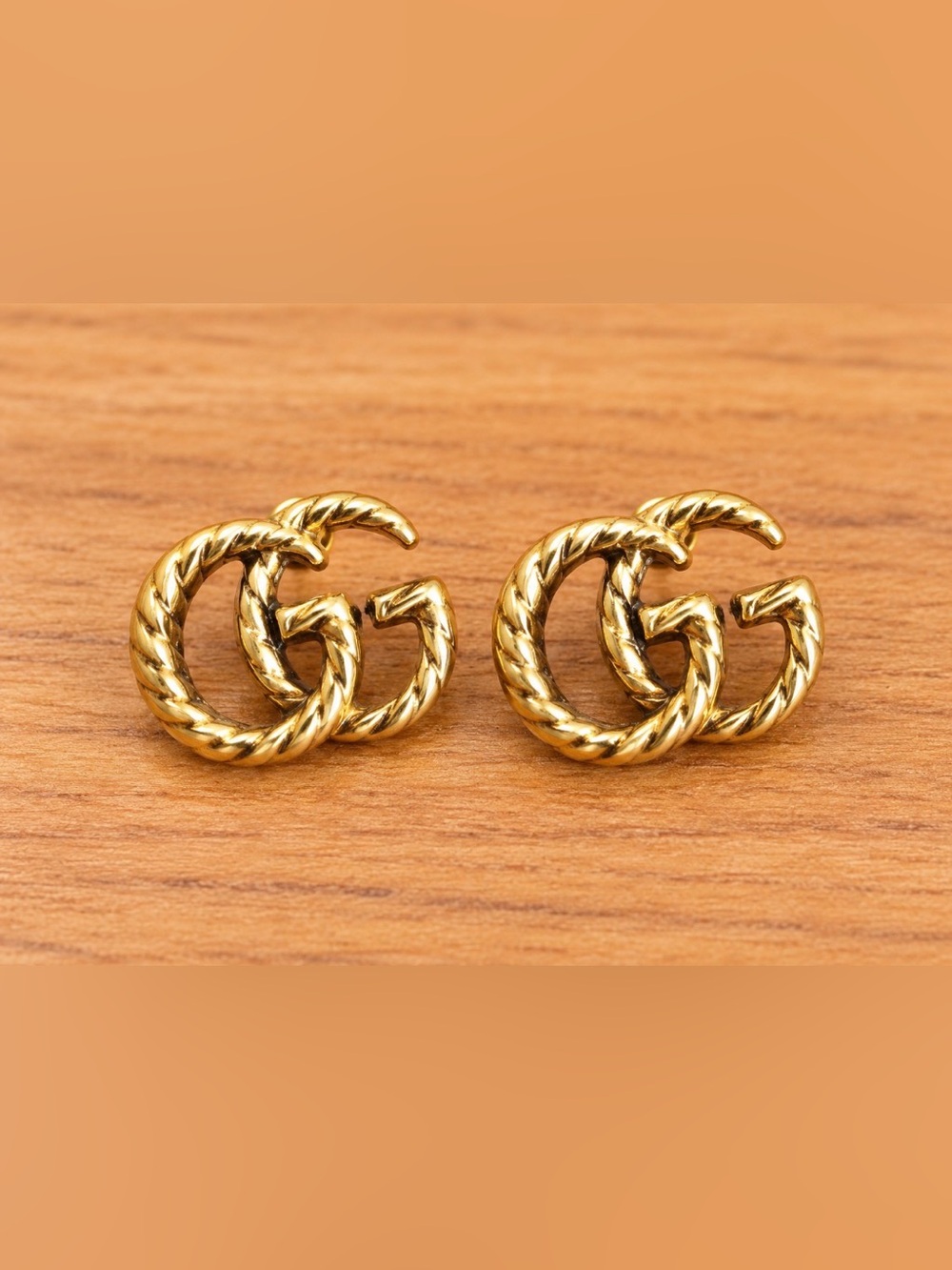 GG Monogram Gold Tone Interlocking Swirl Stud Earrings